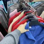 woman chooses a coat jacket in the store a wom 2025 02 25 03 00 07 utc 1