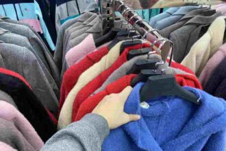 woman chooses a coat jacket in the store a wom 2025 02 25 03 00 07 utc 1