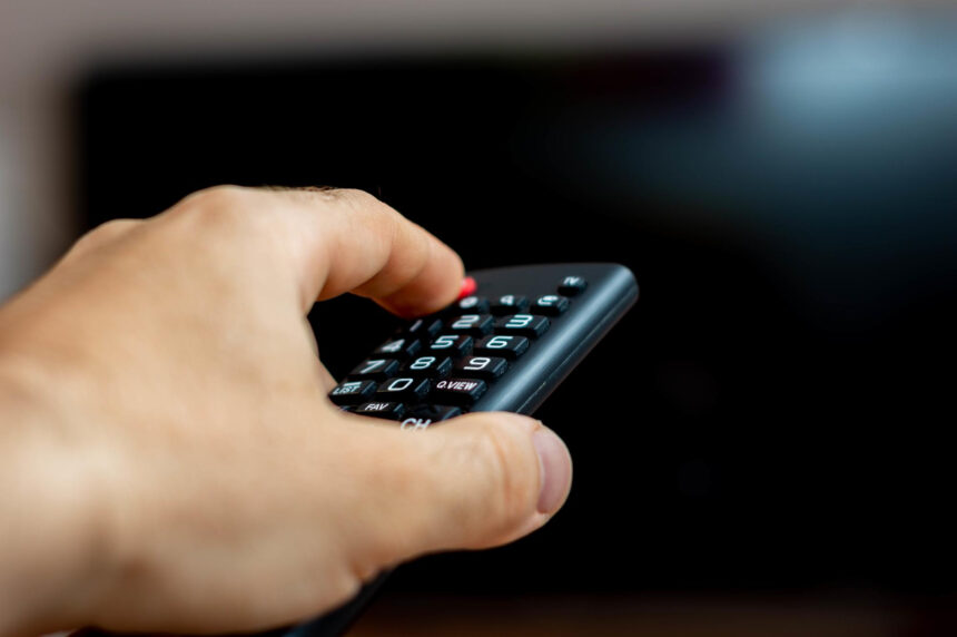 TV Free male hand holding tv remote trying turn tv