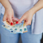 Euro Freepikis holding euro money her hands