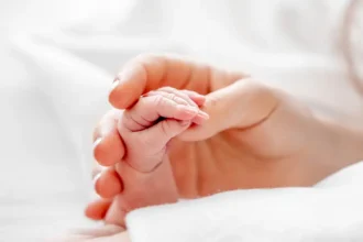 mother holding newborn baby hand 2023 11 27 05 28 17 utc