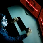 masked hacker under hood using computer to hack in 2025 01 29 23 13 43 utc