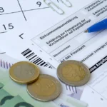 german tax form with pen and european money bills 2025 03 15 23 04 41 utc