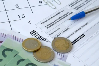 german tax form with pen and european money bills 2025 03 15 23 04 41 utc