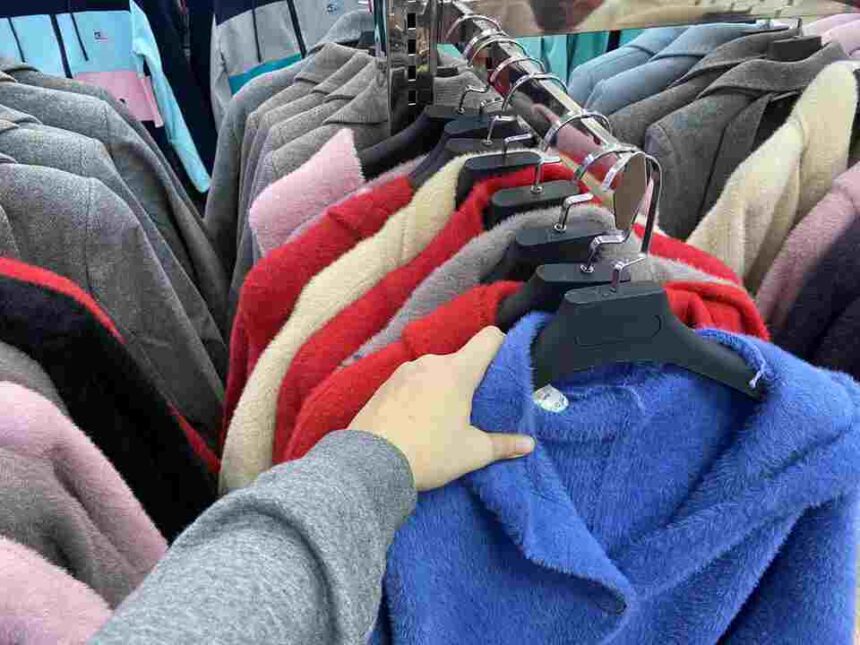 woman chooses a coat jacket in the store a wom 2025 02 25 03 00 07 utc 1